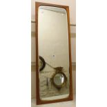 A retro teak framed Danish made wall mirror with bevelled rounded oblong plate