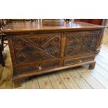 A 3' 7" 19th Century oak mule chest with twin carved panels and two short drawers under, set on