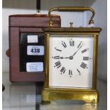 A brass and bevelled glass cased carriage clock in leather case, with eight day strike repeating