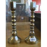 A pair of heavy finely made brass candlesticks with hexagonal tops and bottoms and bobbin stems, set