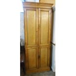 A 34" late 19th Century ash two part cupboard with moulded cornice and shelves enclosed by two pairs