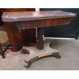 A 36" Victorian mahogany veneered fold over tea table, set on faceted pillar and quatrefoil platform