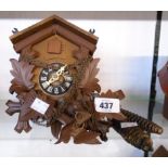 A late 20th Century West German stained wood cuckoo wall clock with cast metal pine cone pattern