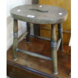 A 19th Century elm seated stool with pierced oval top, set on ring turned supports