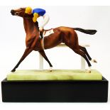 A 6" high mid 20th Century Royal Worcester satin finish figurine of a horse and jockey, Cantering to
