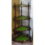 A reproduction mahogany and green leatherette inset four tier what-not