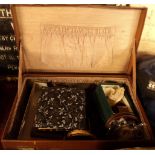 A vintage leather case containing various items including powder compact, inlaid trinket box, etc.