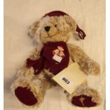 An 8 1/2" Harrods pale brown seated Teddy bear with hat and scarf