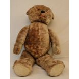 A 34" mid 20th Century straw filled chocolate coloured Teddy bear with poseable limbs