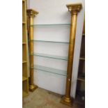 A 3' 10" four glass shelf unit with flanking cast resin and gilt finished Corinthian column