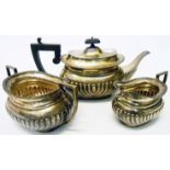 A silver three piece tea set of semi-reeded oval design - Sheffield 1911/12