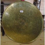A large Chinese circular brass topped occasional table on folding stand, with large central dragon