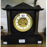 A late Victorian black slate cased mantel clock of architectural design with flanking Corinthian