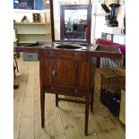 A 17 3/4" late Georgian mahogany gentleman's washstand with ratchet locking rise and fall swing