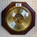 A modern mahogany framed octagonal wall barometer with brass bezel, gilt dial and visible German