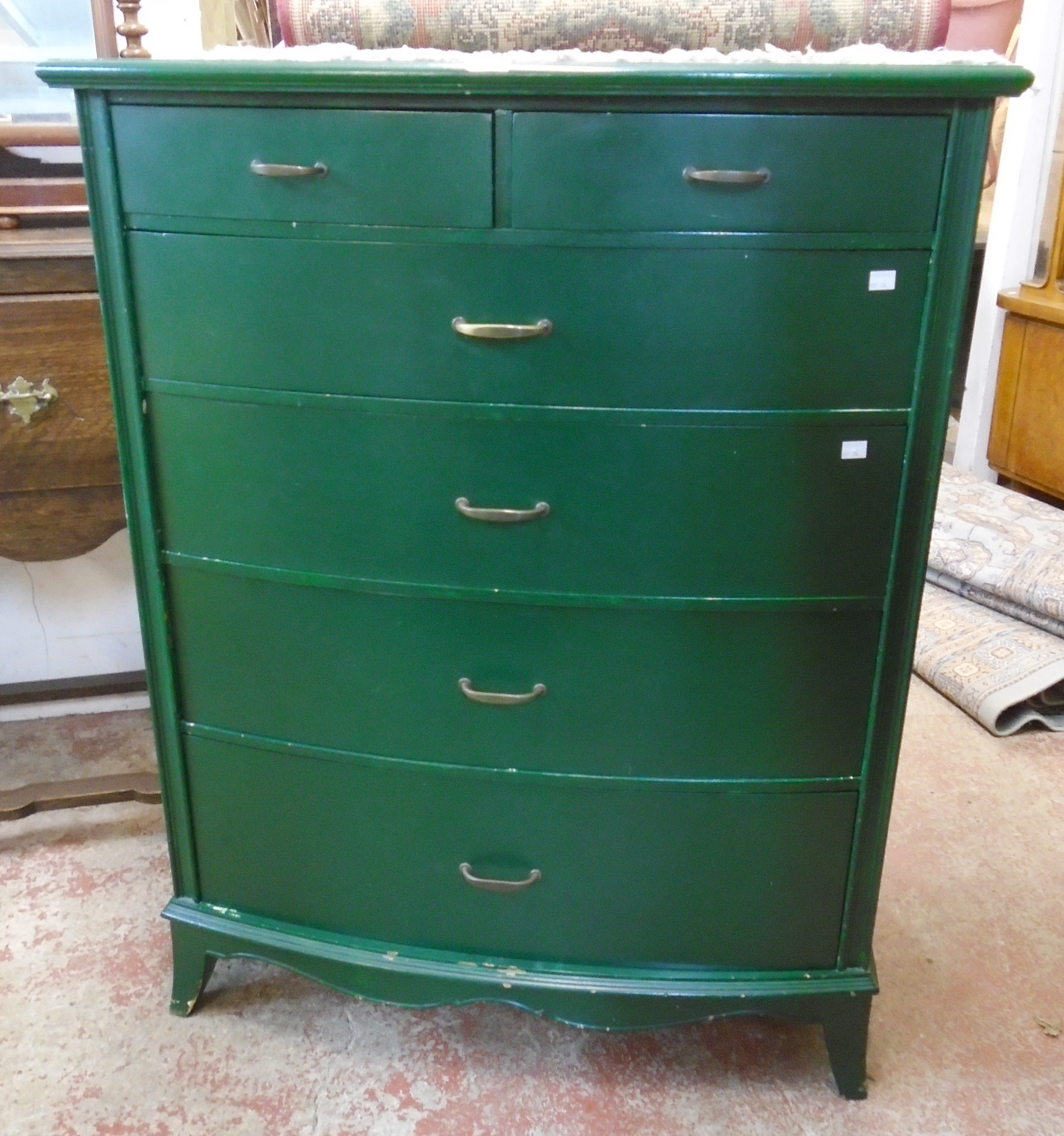 A 36" green painted bow front chest of two short and four long graduated drawers, set on bracket