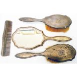 A four piece silver backed dressing table set, comprising two brushes, hand mirror and comb - London