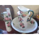 A Wemyss ware jug (cracked) and basin and a pair of slender conical water jugs (one cracked), all