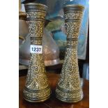 A pair of turned metal vases with profuse engraved gilt decoration