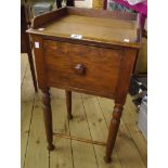 A 16 1/2" 19th Century polished oak bedside pot cupboard with raised gallery and turned supports