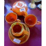 A Barum Pottery tea for two set of eight pieces, in orange and brown finish