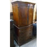 A 28 1/4" reproduction mahogany two part serpentine front drinks cabinet in the style of a