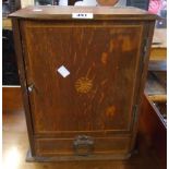 A 12" early 20th Century inlaid oak smoker's cabinet with lift-top and door enclosing fitted