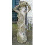 A 4' 3" cast concrete garden statue in the form of a scantily clad classical female figure holding