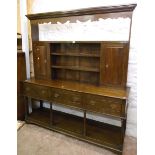 A 6' antique polished oak two part dresser with moulded cornice, shaped frieze and open shelves with