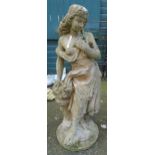 A 4' 3" cast concrete garden statue in the form of a classical maiden carrying a basket of flowers