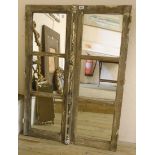 A pair of antique window doors with central bar locking handle, mounted and set with mirror panels -