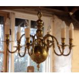 A brass Dutch style six branch chandelier with bulbous finial