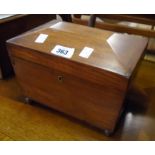 A 9 1/2" Victorian mahogany sarcophagus shaped tea caddy with three internal lids, set on ball feet