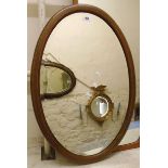 An Edwardian inlaid mahogany framed bevelled oval wall mirror