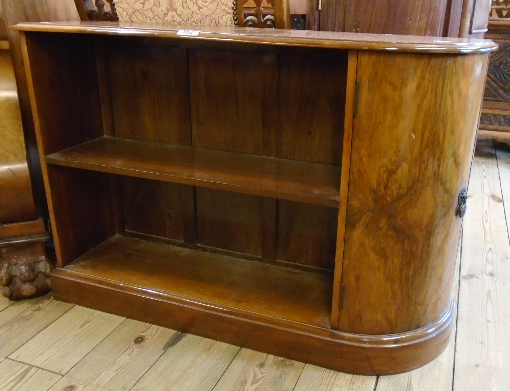 A pair of 35" 1930's walnut bedside units, each with two open shelves and curved ends enclosed by