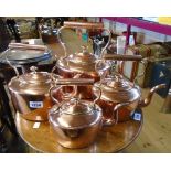 A set of four graduated copper kettles