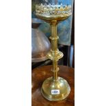 A brass Gothic Revival candlestick with pierced rim - sold with a pierced brass fire fender, a/f
