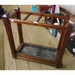 A 24" late Victorian stained pitch pine framed stick/umbrella stand with metal drip tray under