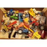 A box containing a small collection of vintage and later diecast farm vehicles and machinery