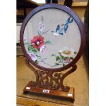 A 12" late 20th Century Oriental polished and stained hardwood framed circular table screen with