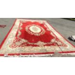A large Chinese wash wool carpet of standard design on red ground - 12' X 18' 4" (366cm X 561cm)