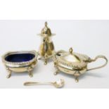 A silver three piece condiment set, comprising mustard and salt with blue glass liners, associated