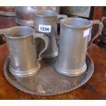 Three pewter tankards and a silver plated tray with pierced rim