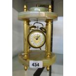 An onyx and brass portico clock stand with vintage alarm clock
