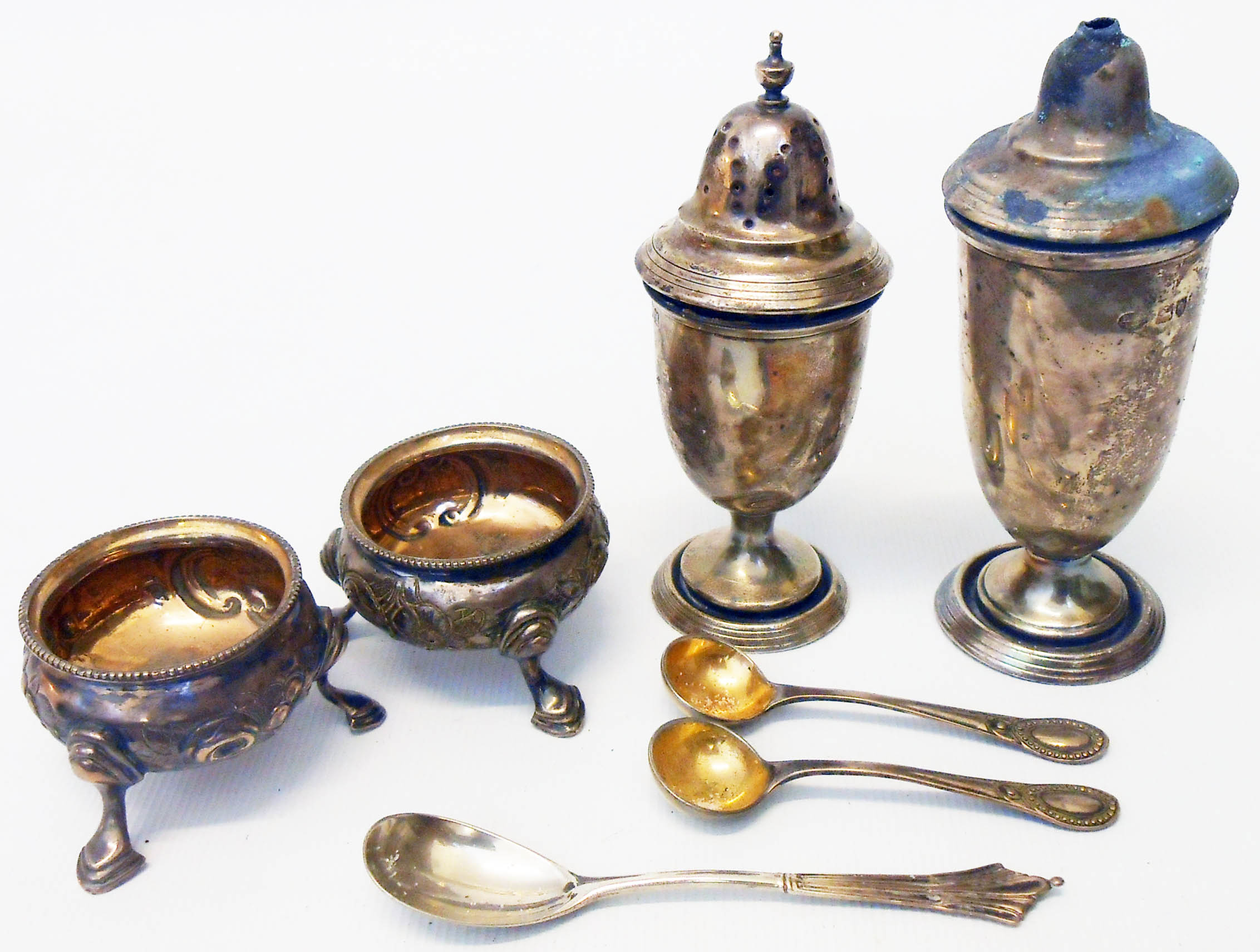 A pair of silver salts - London 1845 - sold with three condiment spoons, silver pepperette and salt