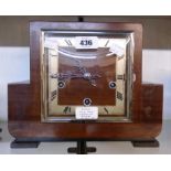 An Art Deco style mahogany cased mantel clock with English eight day chiming movement