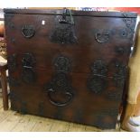 A 36" stained wood grained storage chest with iron carrying handles and Oriental style metal