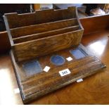 A 13" early 20th Century polished oak desk inkstand with stationery compartment to rear and pen