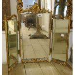 A mid 20th Century ornate gilt framed triple dressing table mirror with bevelled plate