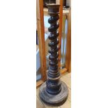 An antique carved and parcel gilt mahogany torchere base with barley twist column and circular